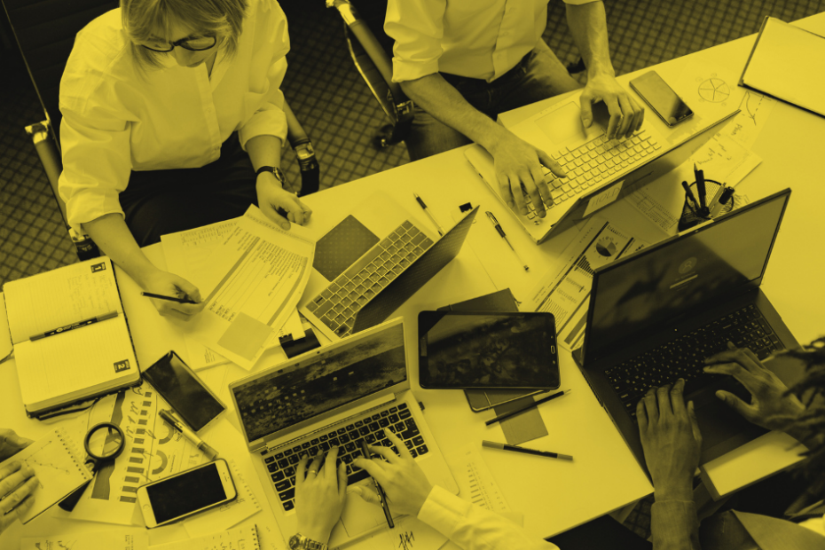 Team of co-workers working individually on open computers