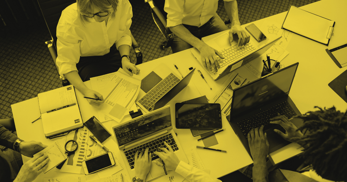 Team of co-workers working individually on open computers